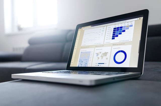 laptop computer with accounting graphs on the screen